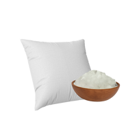 White pillow next to a wooden bowl filled with Shimul tula on a white background