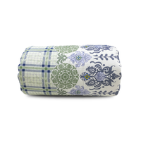 Rolled-up fabric with green, blue, and white patterns on a white background