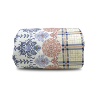 Roll of patterned fabric with floral and checkered designs on a white background