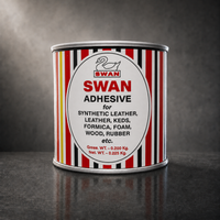 A cylindrical metal can of Swan Adhesive standing upright on a dark reflective surface against a dark gray studio background. The can has a white label with red, black, and yellow vertical stripes and a large white oval in the center reading 'SWAN ADHESIVE' with smaller black text listing compatible materials.