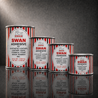 Five cans of Regi Swan Synthetic Leather Adhesive in varying sizes, arranged in a row on a reflective dark gray surface against a dark gray background.